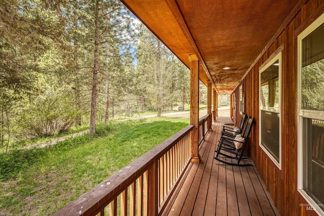 deck with a yard and covered porch