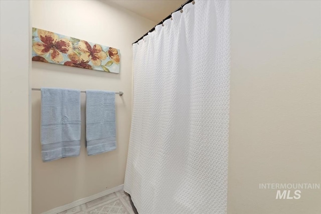bathroom with baseboards and a shower with curtain