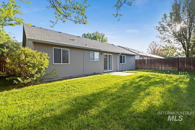 back of property featuring a patio area and a shingled roof