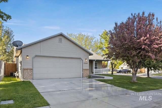 view of front of property featuring brick siding, a garage, driveway, and a porch