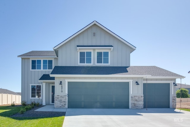 2361 N Lithodora Ave, Star, ID 83669 - view of front of property with board and batten siding, roof with shingles, concrete driveway, and stone siding