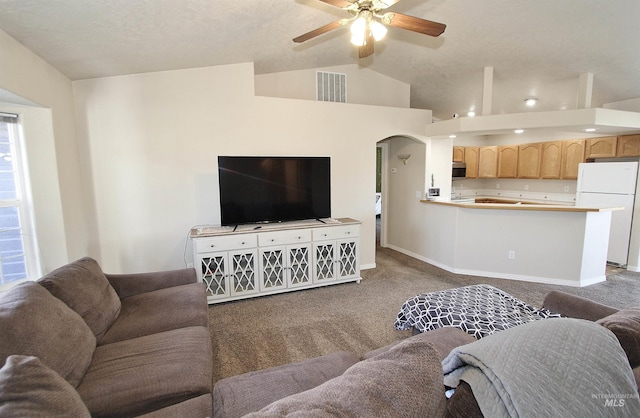 living room featuring vaulted ceiling, carpet floors, and ceiling fan