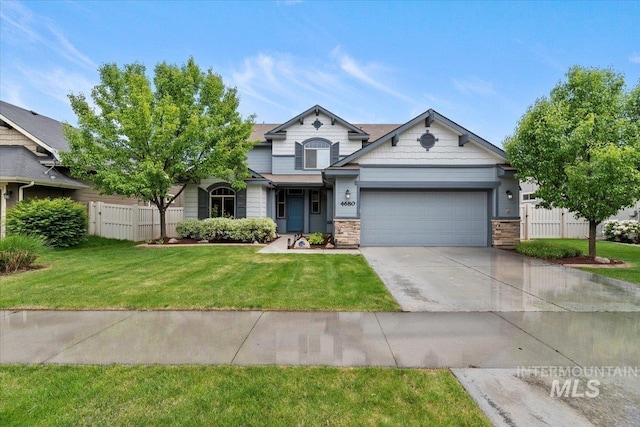 4680 N Maplestone Ave, Meridian, ID 83646 - view of front of house featuring a garage, driveway, and stone siding