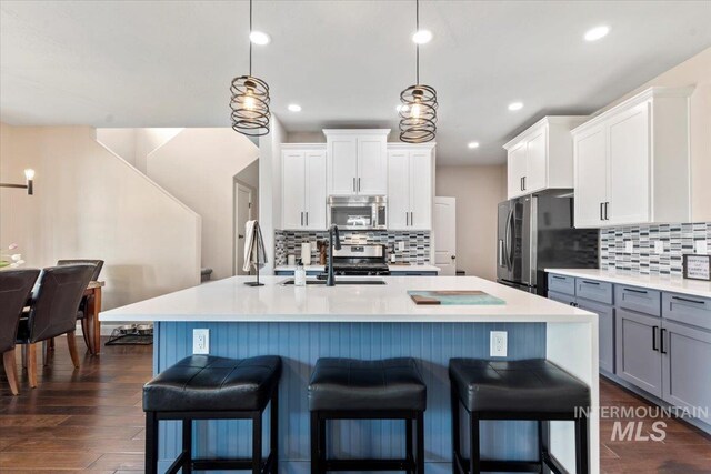 4680 N Maplestone Ave, Meridian, ID 83646 - kitchen featuring stainless steel appliances, a sink, tasteful backsplash, light countertops, and recessed lighting