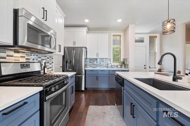 4680 N Maplestone Ave, Meridian, ID 83646 - kitchen featuring appliances with stainless steel finishes, a sink, white cabinets, blue cabinetry, and recessed lighting