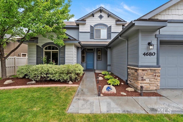 4680 N Maplestone Ave, Meridian, ID 83646 - view of front of property with a garage, fence, and stone siding