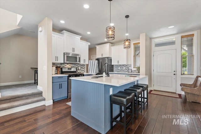 4680 N Maplestone Ave, Meridian, ID 83646 - kitchen with stainless steel appliances, a sink, baseboards, dark wood finished floors, and recessed lighting