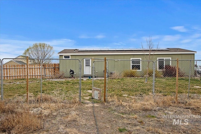 3834 N 2381 E, Filer, ID 83328 - rear view of house featuring a gate and solar panels
