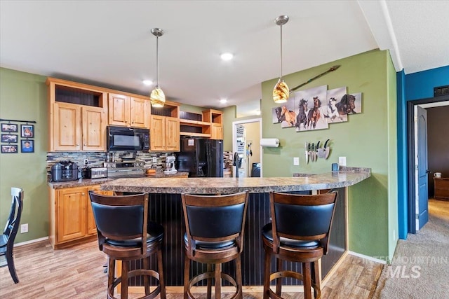 3834 N 2381 E, Filer, ID 83328 - kitchen with black appliances, open shelves, a kitchen bar, tasteful backsplash, and light brown cabinetry