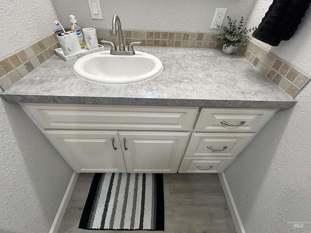 139 119th St, Orofino, ID 83544 - bathroom featuring a textured wall, vanity, baseboards, and wood finished floors