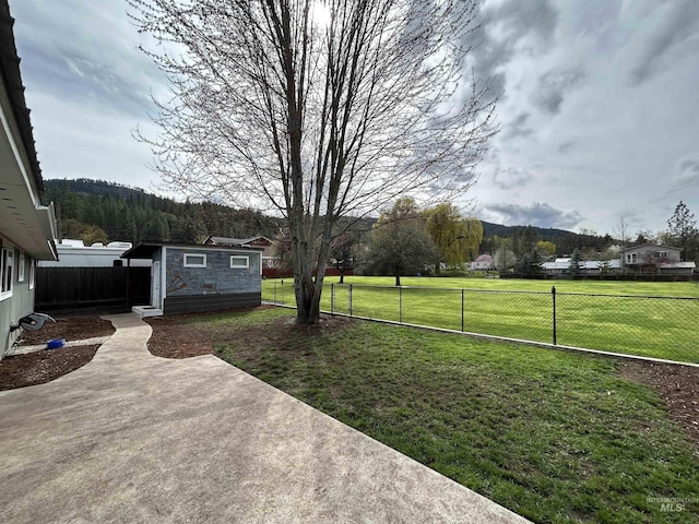 139 119th St, Orofino, ID 83544 - view of yard featuring a patio, a mountain view, a fenced backyard, and an outdoor structure