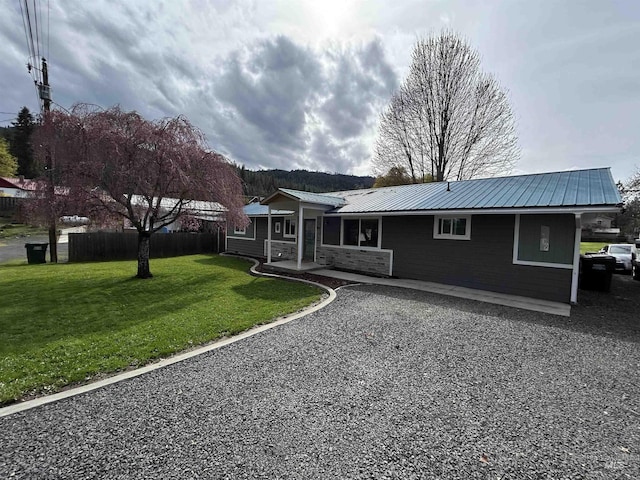 139 119th St, Orofino, ID 83544 - view of front of home with a front yard, metal roof, fence, and a patio