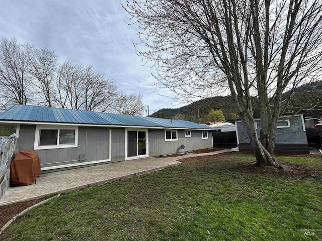 139 119th St, Orofino, ID 83544 - back of property featuring a patio area, metal roof, a yard, and fence