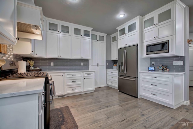 3330 E 4050 N, Twin Falls, ID 83301 - kitchen with light wood-type flooring, appliances with stainless steel finishes, and backsplash