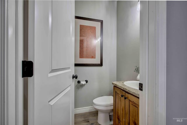 3330 E 4050 N, Twin Falls, ID 83301 - bathroom featuring vanity, baseboards, toilet, and wood finished floors
