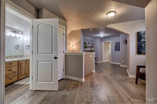 3330 E 4050 N, Twin Falls, ID 83301 - corridor featuring a sink, light wood finished floors, baseboards, and lofted ceiling
