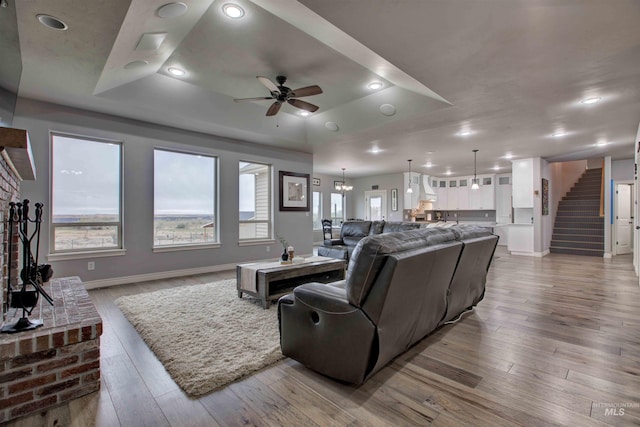 3330 E 4050 N, Twin Falls, ID 83301 - living area featuring ceiling fan, a tray ceiling, wood finished floors, stairs, and baseboards