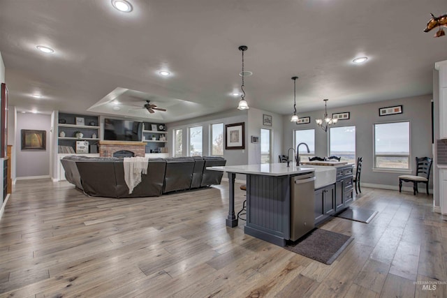 3330 E 4050 N, Twin Falls, ID 83301 - kitchen with baseboards, open floor plan, a center island with sink, dishwasher, and a sink