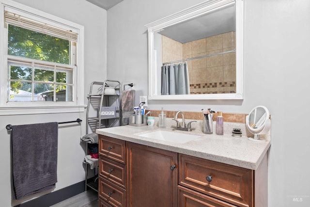 bathroom featuring vanity, hardwood / wood-style flooring, and a shower with shower curtain