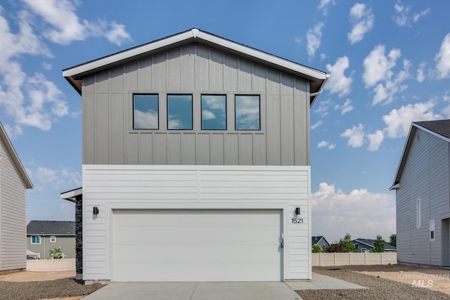 4372 N Magical Creek Ave, Meridian, ID 83646 - view of front of house featuring concrete driveway, board and batten siding, fence, and an attached garage