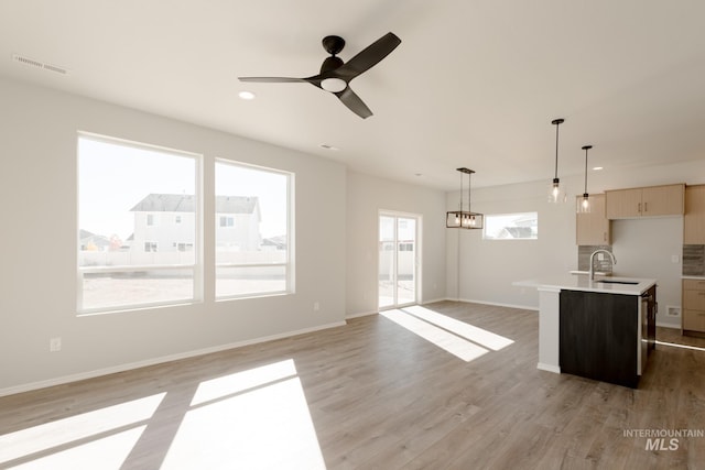 4372 N Magical Creek Ave, Meridian, ID 83646 - interior space with visible vents, light countertops, an island with sink, ceiling fan, and light wood-style flooring