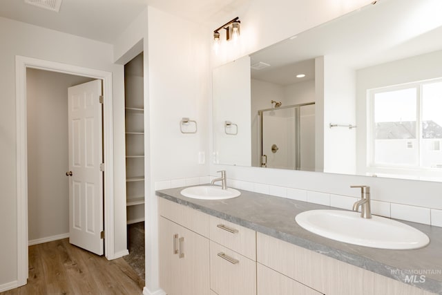 4372 N Magical Creek Ave, Meridian, ID 83646 - full bath with a sink, double vanity, a stall shower, and wood finished floors