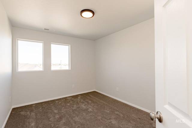 4372 N Magical Creek Ave, Meridian, ID 83646 - spare room featuring baseboards, dark colored carpet, and visible vents