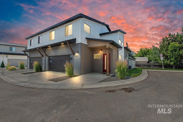 1447 N Pineview Ln, Boise, ID 83713 - view of front of property with board and batten siding, an attached garage, and driveway