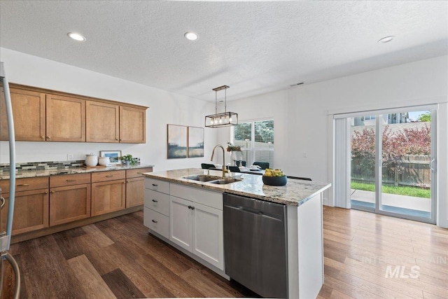 1447 N Pineview Ln, Boise, ID 83713 - kitchen with stainless steel dishwasher, a textured ceiling, dark wood-type flooring, brown cabinetry, and light stone countertops