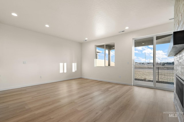 spare room featuring visible vents, recessed lighting, baseboards, and light wood-style floors