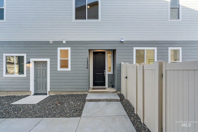 view of exterior entry with fence