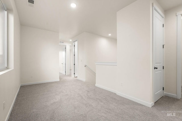 carpeted spare room with visible vents, recessed lighting, and baseboards