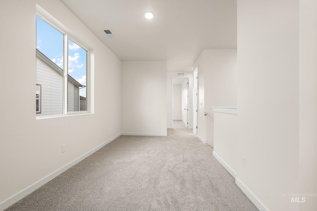 carpeted empty room with recessed lighting and baseboards