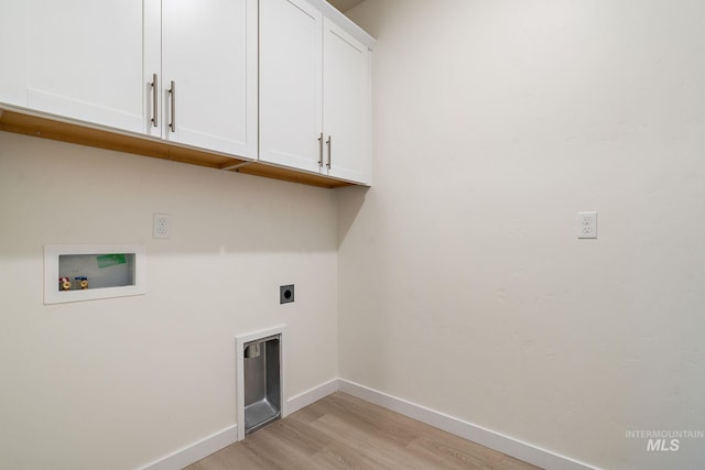 laundry area with washer hookup, cabinet space, light wood finished floors, baseboards, and hookup for an electric dryer