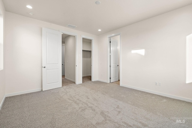 unfurnished bedroom with recessed lighting, carpet, visible vents, and baseboards