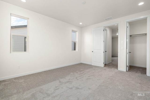 unfurnished bedroom with recessed lighting, baseboards, carpet floors, and visible vents