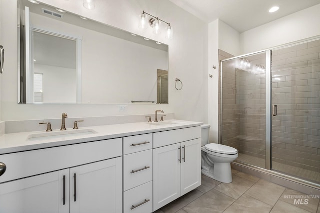 full bath with a sink, visible vents, toilet, and a shower stall