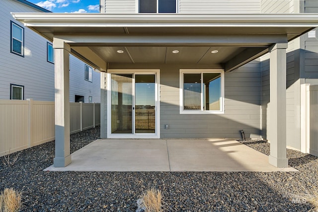 property entrance featuring a patio area and fence