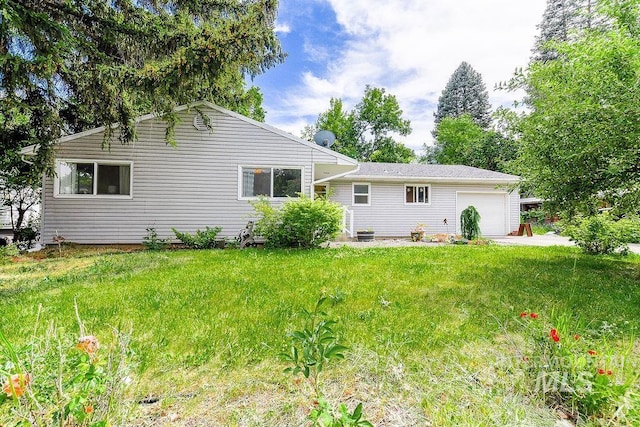 1021 E 5th St, Moscow, ID 83843 - rear view of house featuring an attached garage and a lawn