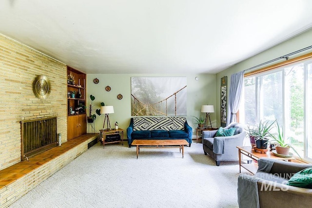 1021 E 5th St, Moscow, ID 83843 - carpeted living area with healthy amount of natural light, a fireplace, and built in shelves