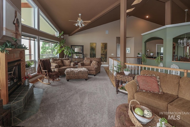 carpeted living room with high vaulted ceiling, ceiling fan, and a tile fireplace