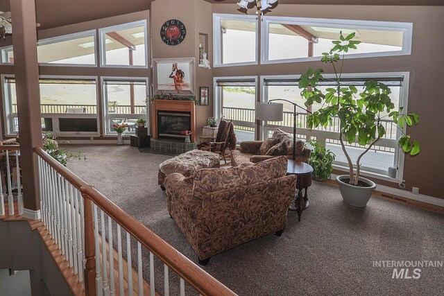 living room featuring a tiled fireplace and carpet floors