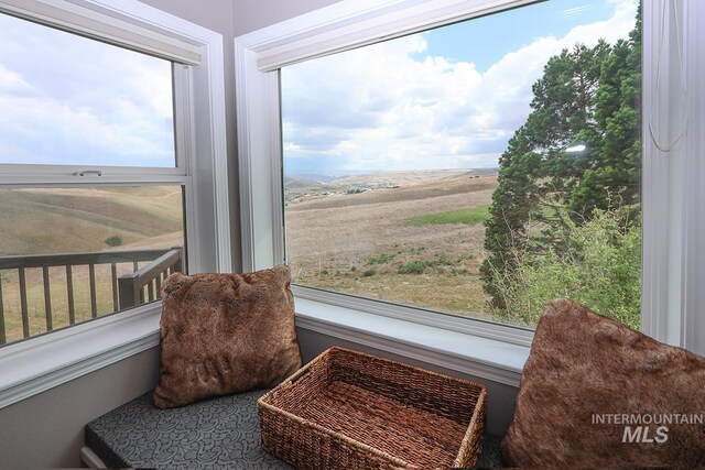 sunroom featuring plenty of natural light and a rural view