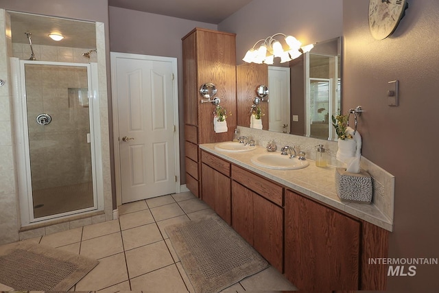 bathroom with tile patterned flooring, walk in shower, and vanity