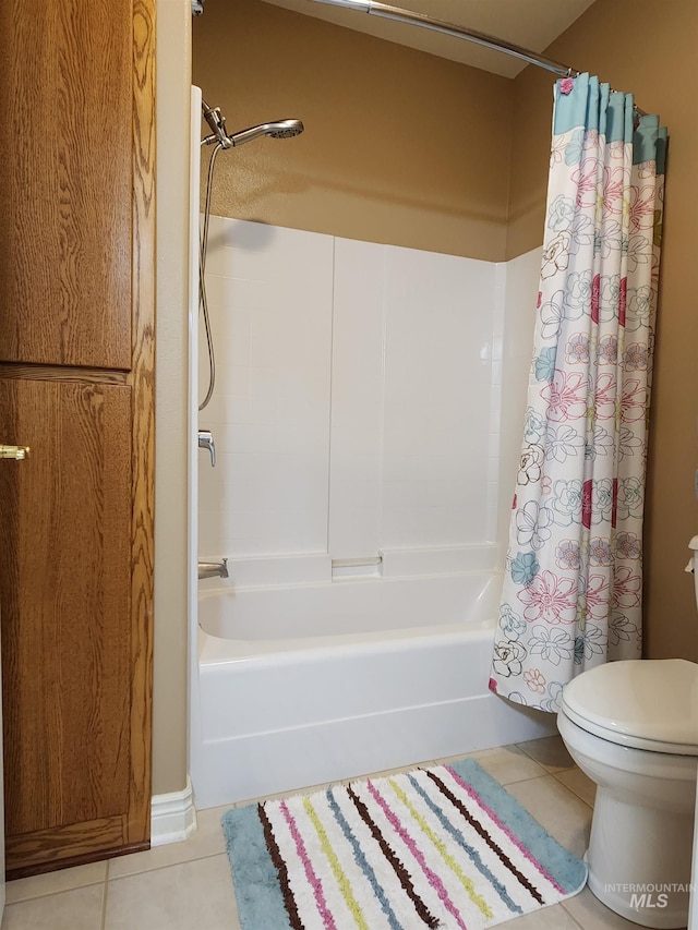 bathroom featuring tile patterned floors, toilet, and shower / bathtub combination with curtain