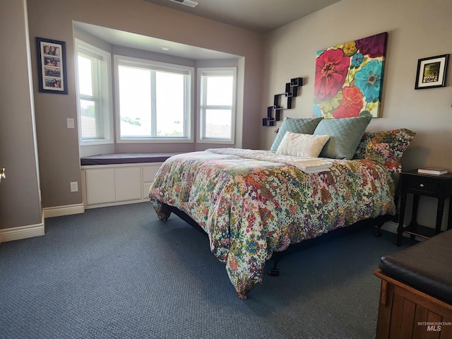 bedroom featuring dark carpet