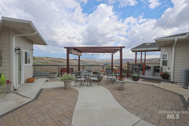 view of patio with a mountain view, a pergola, and cooling unit