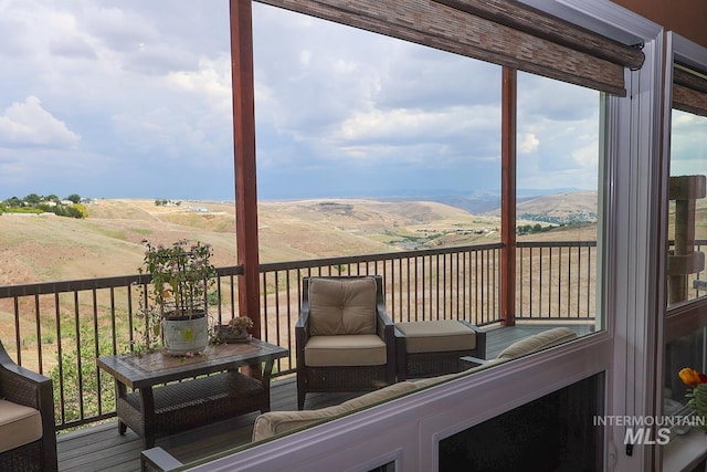 wooden deck featuring a mountain view and a rural view