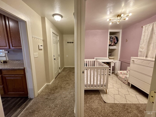 bedroom featuring light carpet and a notable chandelier