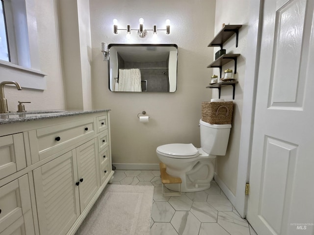 bathroom with vanity, tile patterned flooring, and toilet